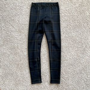 Barley worn, dark navy plaid leggings with light gold and dark maroon accents.